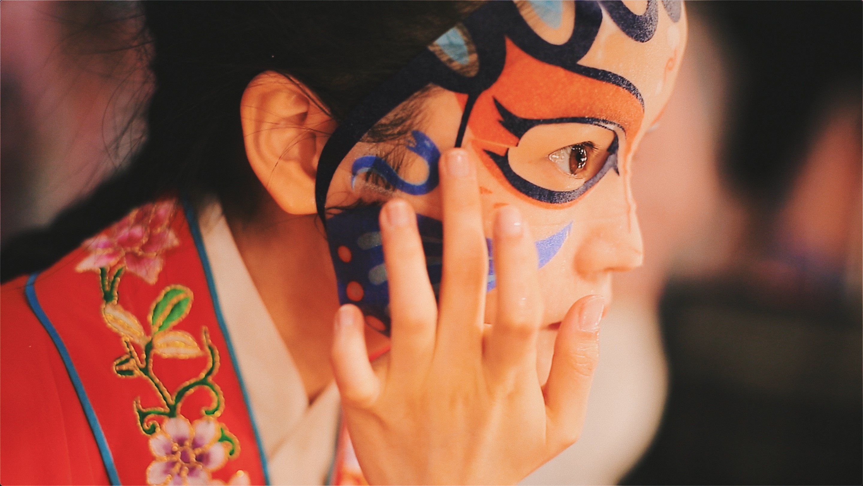 Chinese woman using Sichuan Opera facial mask