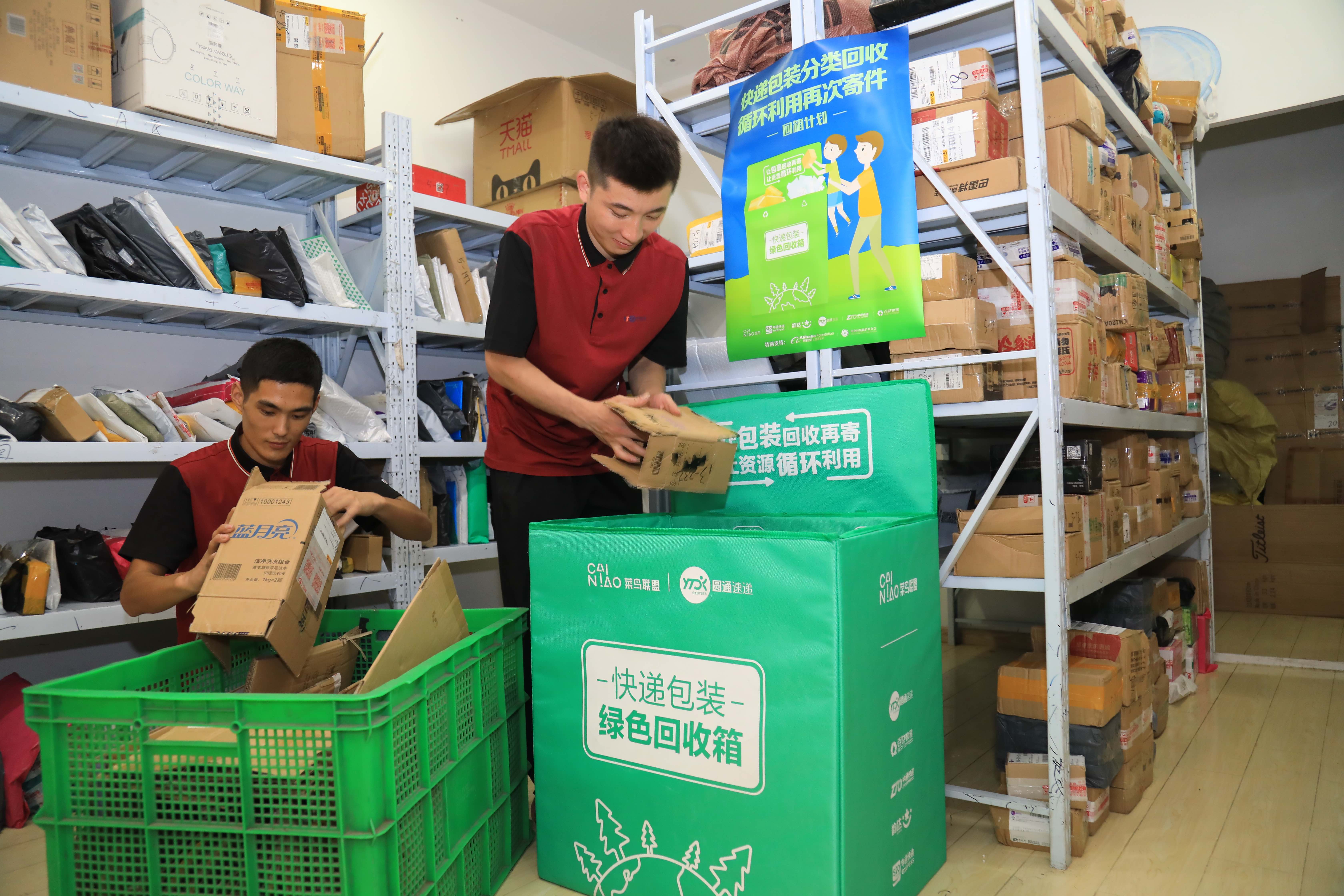 Couriers sorting out recycled boxes