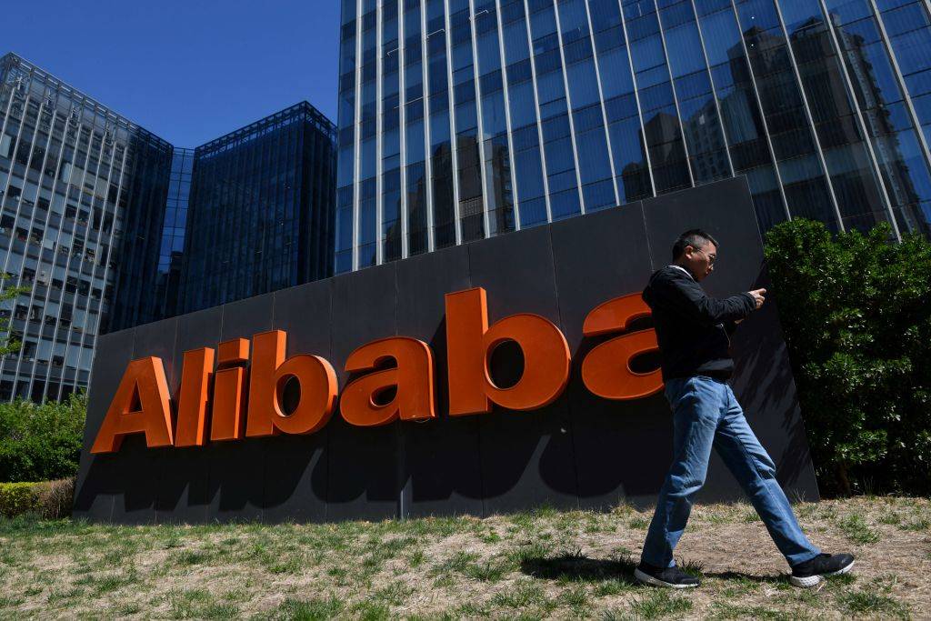 A man walks past an Alibaba sign outside the company’s office in Beijing on April 13, 2021. (Photo by GREG BAKER / AFP) (Photo by GREG BAKER/AFP via Getty Images)