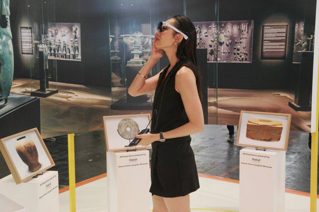 Fliggy’s Ada Xu wearing AR glasses to interact with virtual exhibits. Photo credit: Alibaba Group
